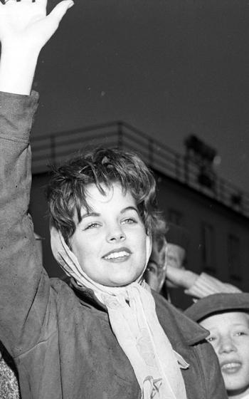 A teenage Priscilla Beaulieu, who later married Elvis Presley and became Priscilla Presley, waves.