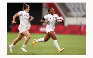The United States' Kristi Kirshe (12) looks on as teammate Ariana Ramsey (9) breaks away to score a try in the a pool match against Japan during the Rugby Sevens on Day 6 of the Tokyo 2020 Olympic Games at Tokyo Stadium on July 29, 2021, in Chofu, Tokyo, Japan. (Dan Mullan/Getty Images/TNS)
