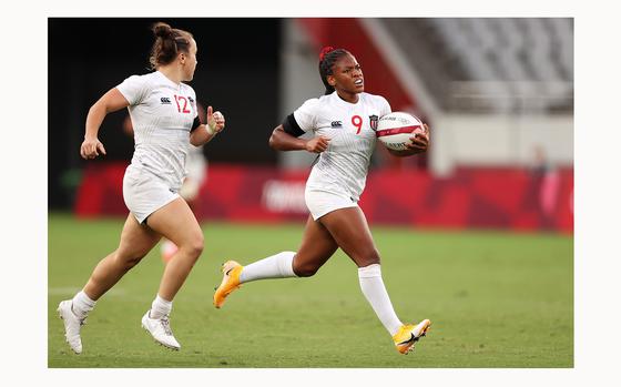 The United States' Kristi Kirshe (12) looks on as teammate Ariana Ramsey (9) breaks away to score a try in the a pool match against Japan during the Rugby Sevens on Day 6 of the Tokyo 2020 Olympic Games at Tokyo Stadium on July 29, 2021, in Chofu, Tokyo, Japan. (Dan Mullan/Getty Images/TNS)