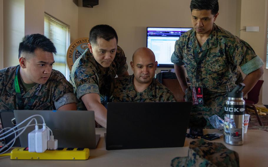 Marines from Defensive Cyberspace Operations-Internal Defensive Measures, Company B, 6th Communication Battalion, discuss their network hacking plans during exercise Cyber Yankee 22 at Camp Nett in Niantic, Conn., June 13, 2022. While most of the Navy, Army, and Air Force cyber career fields were staffed at 80% or higher, four of six Marine Corps cyber career fields were below 80% of authorized levels in fiscal year 2021.