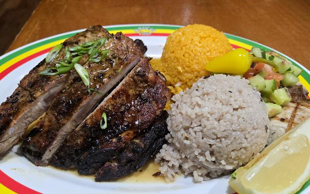 The triple combo from the Jamaican Grill on Guam includes spicy jerk-style chicken, juicy ribs, fresh fish, rice and salad. 