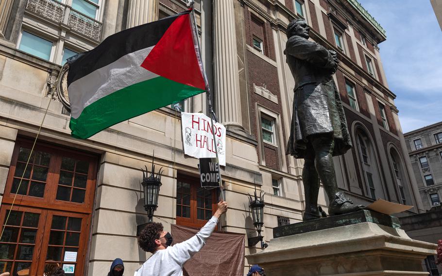 Pro-Palestinian student protesters wave a Palestinian flag as they gather on the front steps of Hamilton Hall at Columbia University in New York City on April 30, 2024. 