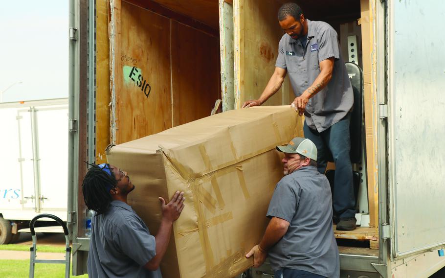 Workers from River City Movers conduct a delivery in May 2022 for a soldier at Fort Campbell, Ky., whose belongings were transported overseas from his previous duty station in Germany.