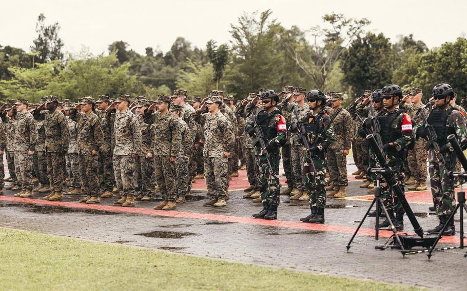 U.S. and Indonesian Marines stand in formation and salute.