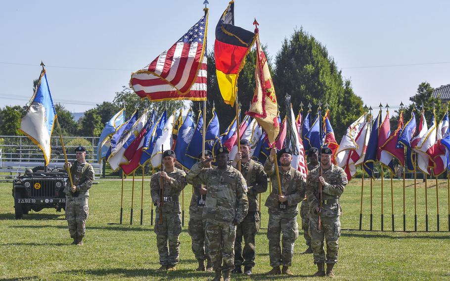 U.S. Army Garrison Wiesbaden Command Sgt. Maj. Yves Pamphil salutes with a U.S. and German color guard during a change of command ceremony June 26, 2024, in Wiesbaden, Germany.