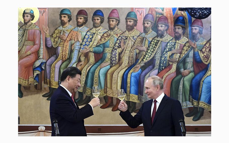 Russian President Vladimir Putin, right, and Chinese President Xi Jinping toast during their dinner at The Palace of the Facets, a building in the Moscow Kremlin, Russia, on March 21, 2023. 