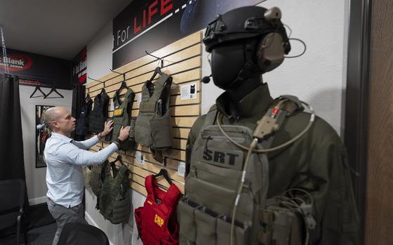 Veteran and business owner Jackson Dalton arranges protective gear at the Black Box Safety offices, Thursday, Nov. 7, 2024, in El Cajon, Calif. (AP Photo/Gregory Bull)