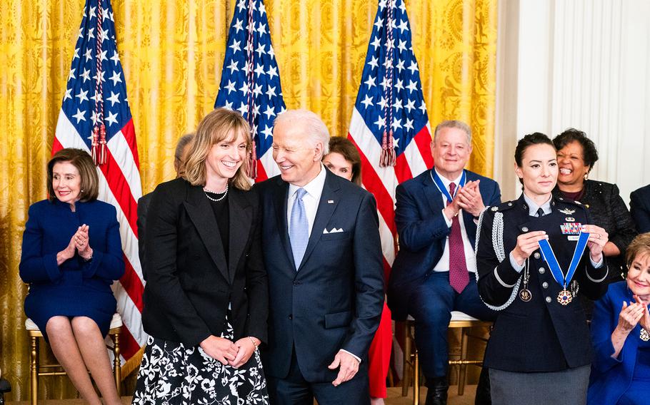 Katie Ledecky and President Joe Biden share a laugh during the Presidential Medal of Freedom ceremony at the White House on Friday, May 3, 2024.