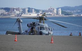 A Navy Seahawk helicopter is parked on a beach outside of Tokyo.