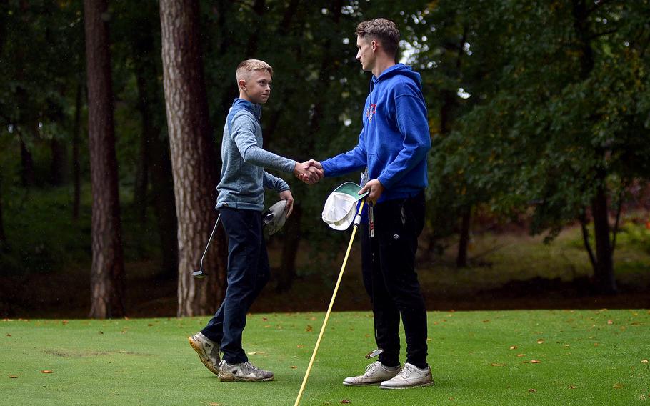 Tyler Korell and Grayden Taylor shake hands.