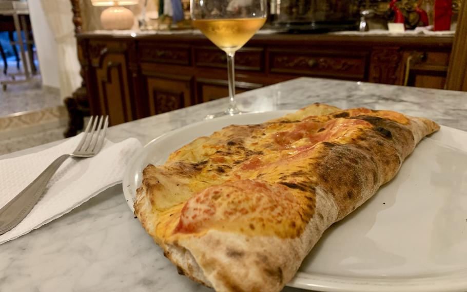 One ripieno, or stuffed pizza, at Antica Pizzeria Chiaia in Naples, Italy, features escarole, olives, capers, anchovies and cheese baked in the restaurant’s signature pizza dough. 