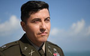 Lt. Col. William Hogan on June 6, 2024, at an observation point overlooking Omaha Beach in Normandy, France, where his father, Lt. Col. Samuel Hogan, landed during World War II. The elder Hogan commanded a tank battalion, which is the subject of a book written by his son that was published in November. 