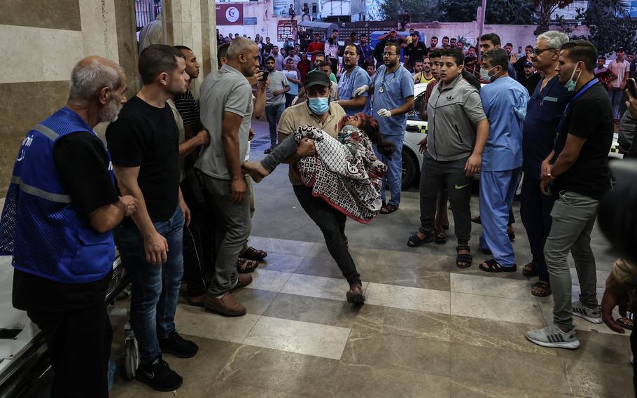 An injured child is brought to Nasser Hospital in Khan Younis on Oct. 26, 2023.