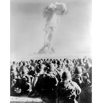 Members of 11th Airborne Division watch the mushroom cloud of an atomic bomb test at Frenchman’s Flat in Nevada in November 1951.
