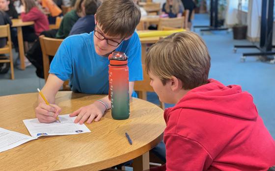 Aviano Middle High School seventh grader William Wolfe, left, interviews Rocco Brunetti of Scuola Media Italo Svevo on Dec. 13, 2024, during a cultural exchange at the school on Aviano Air Base in Italy.