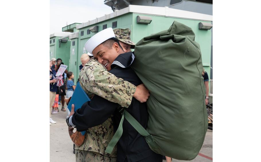 Hospital Corpsman 2nd Class Jesus Ayala reunites with a Sailor 