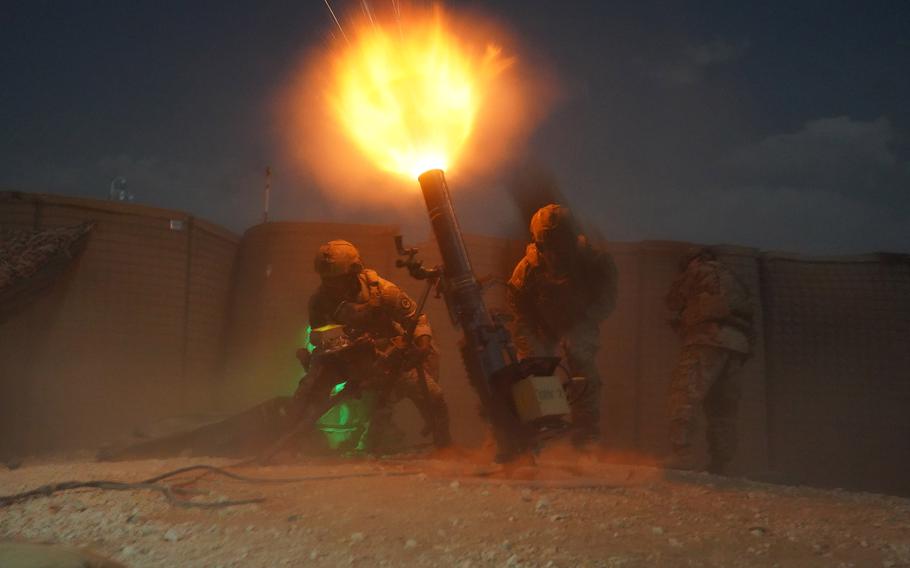 U.S. soldiers fire an M121 120 mm mortar system in Syria.