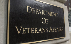 A brown sign with gold letters reading “Department of Veterans Affairs” on the side of the agency’s headquarters building.