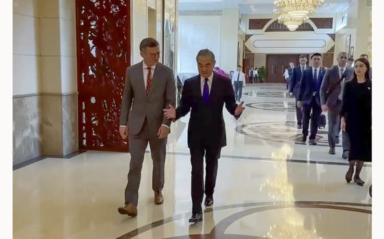 In this image taken from video released by the Ukraine Ministry of Foreign Affairs, Ukraine's Foreign Ministry Dmytro Kuleba, left walks with China's Foreign Minister Wang Yi before a meeting in the southern Chinese city of Guangzhou on Wednesday, July 24, 2024. Ukraine's foreign minister says he is seeking "common ground" in talks with his Chinese counterpart on ending his country's war with Russia. It is the first visit by a Ukrainian foreign minister since the war started in 2022. (Ukraine's Ministry of Foreign Affairs via AP)