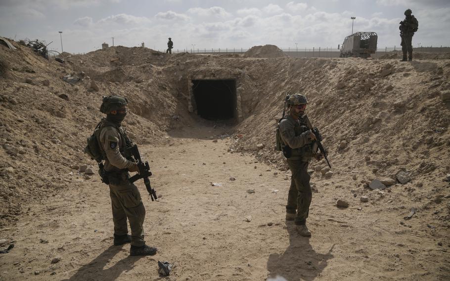 Israeli soldiers take up positions outside a tunnel near the Philadelphia Corridor along the Gaza-Egypt border which the military says was used by Hamas militants.