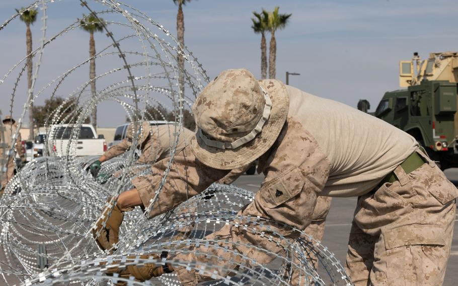 Marines set up concertina wire