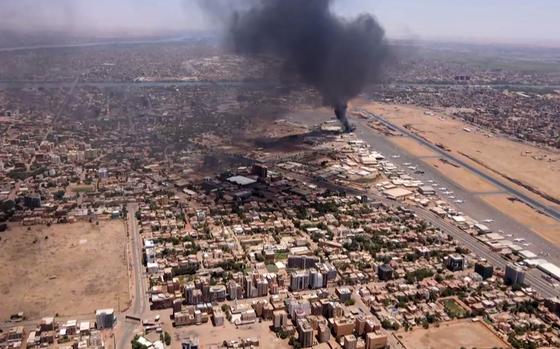 A screen grab taken from AFPTV video footage on April 20, 2023, shows an aerial view of black smoke rising above the Khartoum International Airport amid ongoing battles between the forces of two rival generals. Hundreds of people have been killed since the fighting erupted on April 15 between forces loyal to Sudan's army chief Abdel Fattah al-Burhan and his deputy, Mohamed Hamdan Daglo, who commands the paramilitary Rapid Support Forces (RSF). (AFP via Getty Images/TNS)