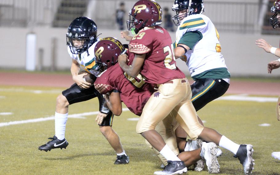 Perry defenders Braylon Stephens and Travis Walker try to wrap up Edgren quarterback Haruki Jones.