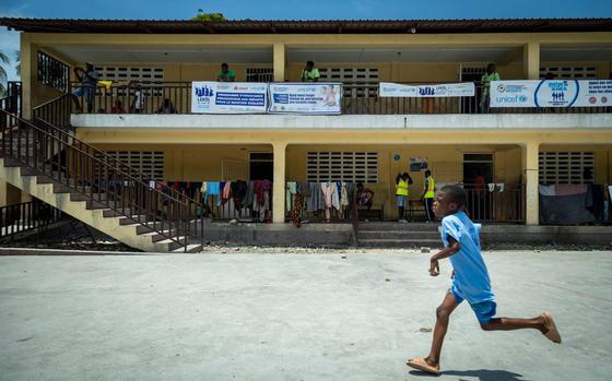 A boy runs across the schoolyard at Ecole National Joseph C. Bernard DeFreres displacement camp in Port-au-Prince, Haiti, on Aug. 27, 2024. Residents who have been forced to abandon their homes due to gang violence have sought refuge in this school rather than face the consequences of staying in gang-occupied territory.