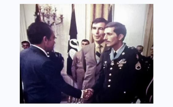 Vietnam veteran Franklin D. Miller shakes hands with former President ...