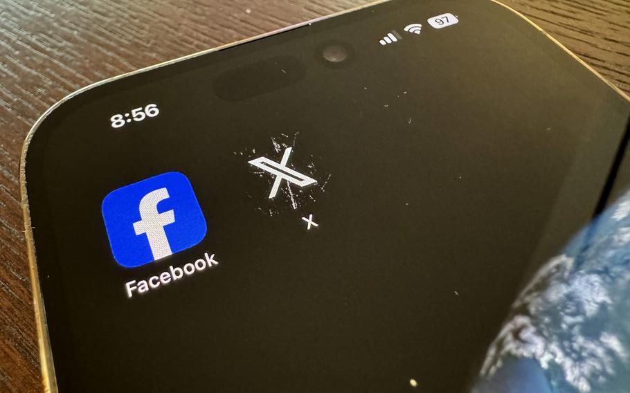 A facebook and X logo on an iphone.