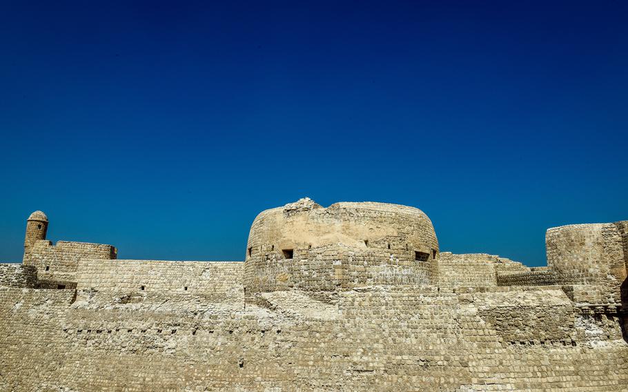 Remains of defensive walls of Bahrain Fort under a blue sky. In the mid-20th century, archaeologists began to excavate the Bahrain Fort, revealing multiple layers of human habitation that spanned millennia.The fort and the surrounding area contain artifacts from the Dilmun civilization, Hellenistic period, early Islamic era and Portuguese period.