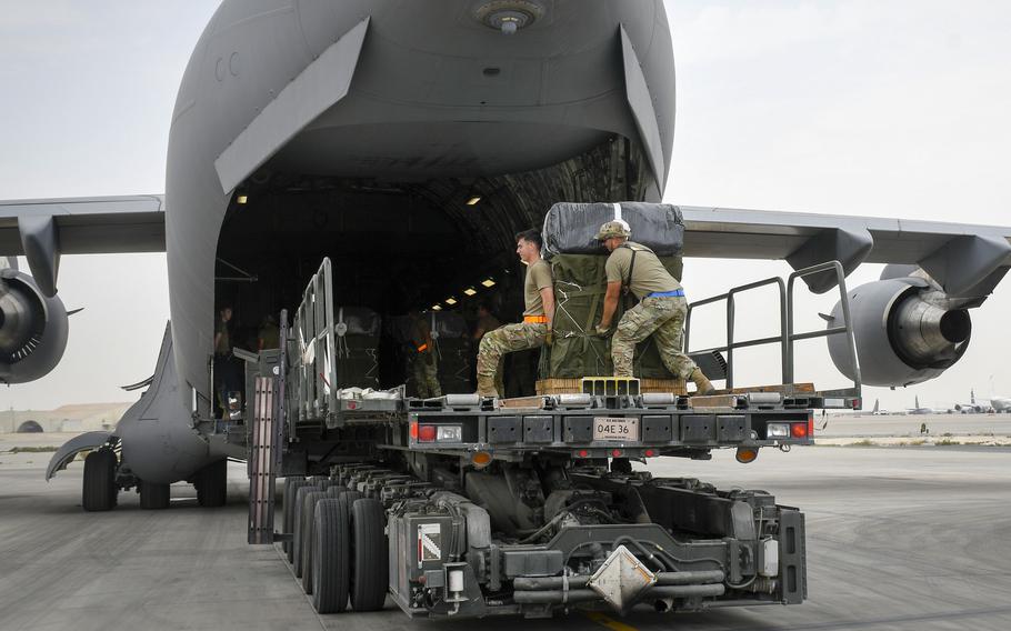 Soldiers with a bundle of humanitarian aid