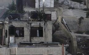 Israeli soldiers look over a rooftop where two bodies lie motionless during a raid in the West Bank town of Qabatiya on Sept.19, 2024.