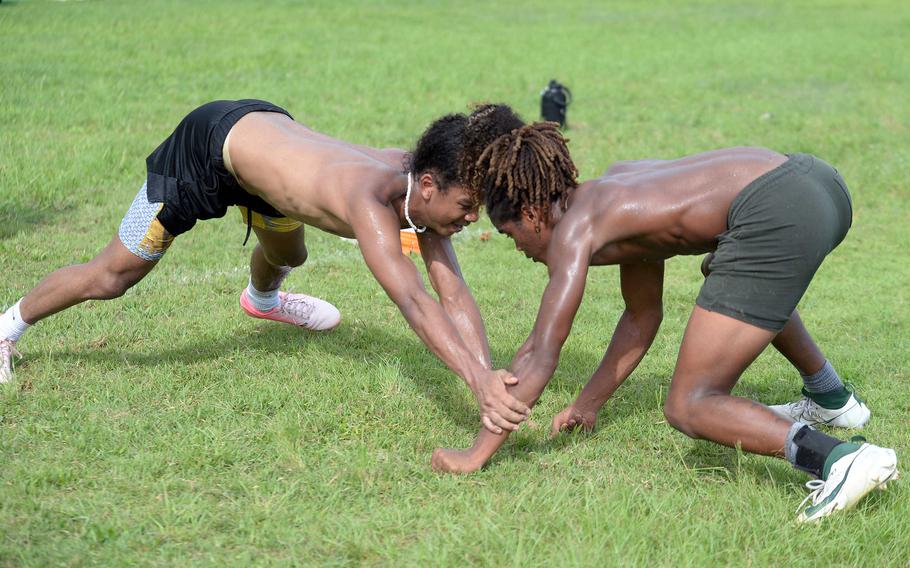 Kubasaki skill positions players Mo Brown and Carlos Cadet try to knock each other off balance in a drill the team dubbed “S’il vous plank,” partly in homage to the Paris Summer Olympics.