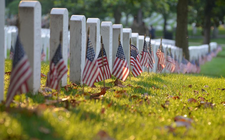 Flags placed at the graves of those buried at Arlington National Cemetery, Va., on May 23, 2024.