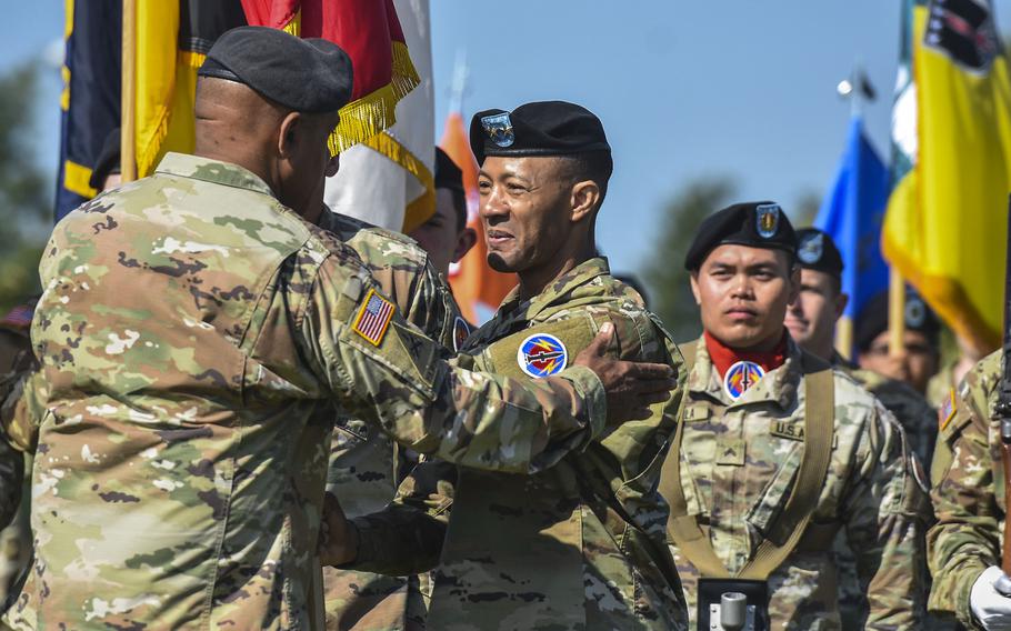 Outgoing commanding general of the 56th Artillery Command, Maj. Gen. Andrew Gainey, passes the unit colors to Gen. Darryl Williams as he relinquishes command of the unit during a ceremony June 13, 2024, on Clay Kaserne in Wiesbaden, Germany.