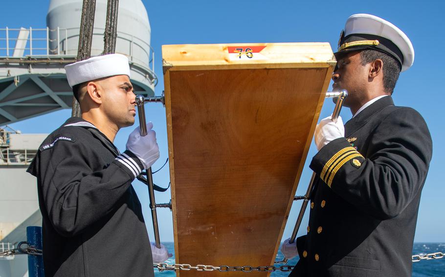 Sailors lay to rest the remains of former Navy junior officer Marc Rockwell-Pate, Sept. 30, 2024, during a burial at sea aboard the aircraft carrier USS Ronald Reagan while underway in the U.S. 3rd Fleet area of operations in the Pacific Ocean.