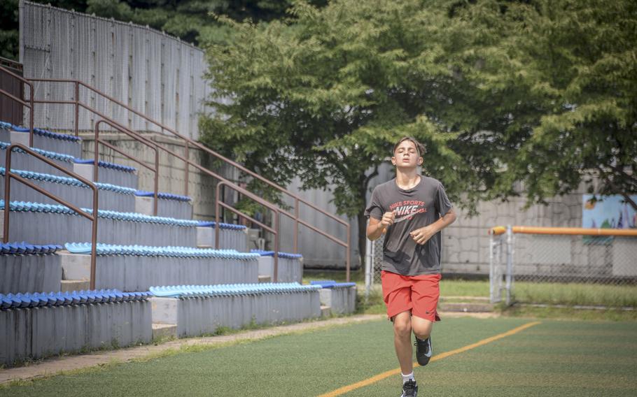 Adrian Baldwin, a ninth grade student of Osan Middle High School, runs during football practice at Osan Air Base, South Korea, Monday, Aug. 5, 2024.