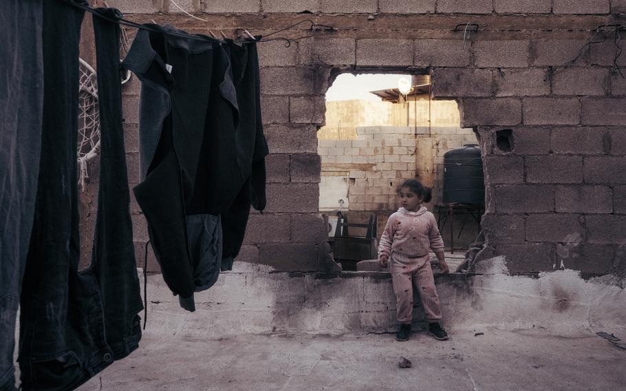 A young girl sits in a house damaged by an Israeli blast in the al-Damaj neighborhood in the Jenin refugee camp on Nov. 30, 2023. 