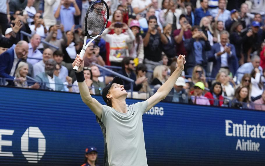 Jannik Sinner raises his arms in celebration