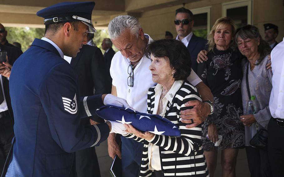 An Air Force member presents a flag to the late Air Force Col. James Abraham’s wife, Jo Abraham, at his funeral at the Southern Nevada Veterans Memorial Cemetery in Boulder City, Nevada, on Monday, May 15, 2023. 