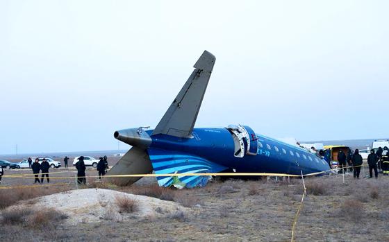 In this photo taken from a video released by the administration of Mangystau region, a part of Azerbaijan Airlines' Embraer 190 lies on the ground near the airport of Aktau, Kazakhstan, on Thursday, Dec. 26, 2024. (The Administration of Mangystau Region via AP)