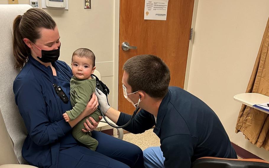 Pediatrician Capt. Michael Zimmerman, with the help of Kaylin Bowers, a registered nurse, assesses a five-month-old infant for RSV. Federal regulators on Monday approved a maternal RSV vaccine administered during pregnancy to protect infants from severe illness.