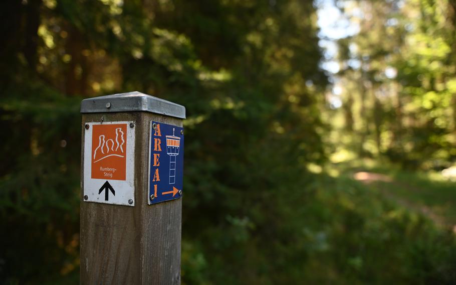 A signpost along the trail points the way to Area 1 and the Rumberg sandstone columns, leading hikers through a journey of history and nature. The trail is well-marked and easy to follow.