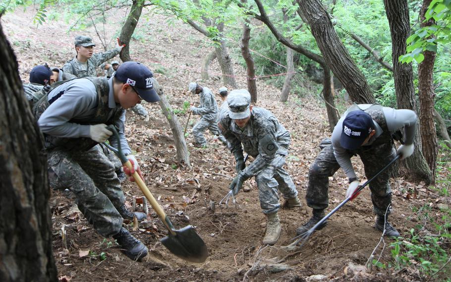 U.S. soldiers participate in an excavation