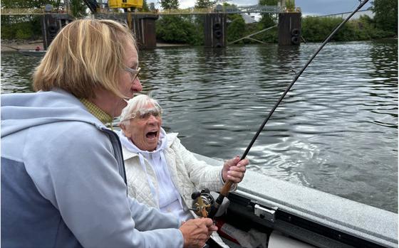 Even at 100 years old, Betsy Jeffords is both strong enough to hang on to a salmon-tugging rod and excited enough to scream with delight as her daughter, Susan Jeffords, helps her reel.