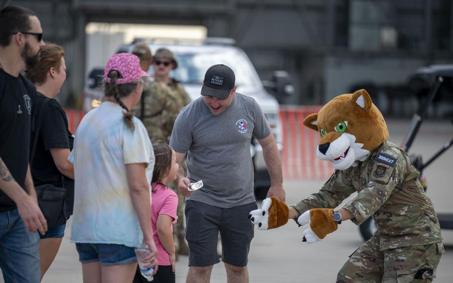 Families are greeted by McConnell Air show mascot Duke Boomcat on Aug. 24 at McConnell Air Force Base, Kan. 