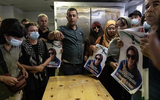 Palestinians and international activists inside the morgue Sunday where the body of slain Turkish American activist Aysenur Eygi is being kept, in Nablus in the occupied West Bank. MUST CREDIT: Heidi Levine for The Washington Post