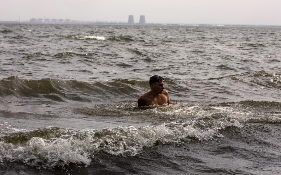 A man swimming across the Dnieper River from the Zaporizhzhia nuclear complex, which is under the control of Russian forces, on Aug. 15, 2022. 