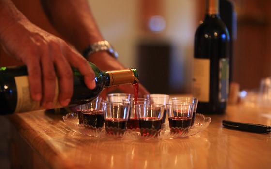 Wine is poured into glasses during a wine tasting event held for spouses of servicemembers with 8th Engineer Support Battalion, 2nd Marine Logistics Group at the Stone Street Community Center aboard Camp Lejeune, N.C., April 30, 2013. The guests tried a variety of wines and learned about some of the characteristics of each wine.